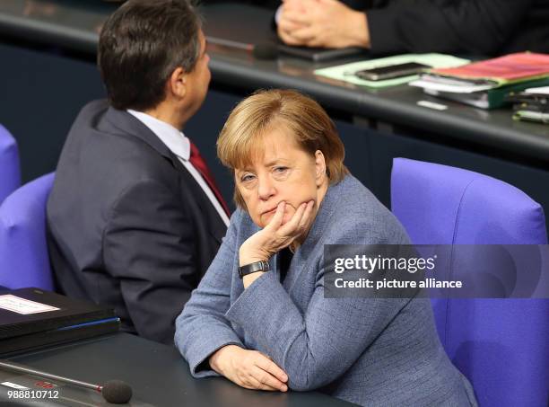 Dpatop - German Chancellor Angela Merkel and Foreign Minister Sigmar Gabriel attend a session of the lower house of parliament at the Bundestag in...
