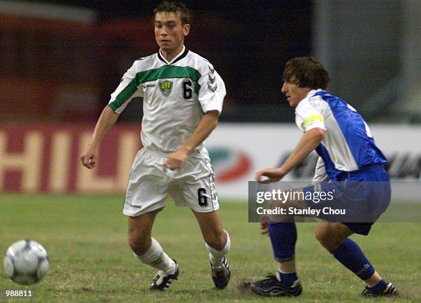 Seytkamalov Bakhodir of Uzbekistan shields the ball away from Mirsad Beslija of Bosnia & Herzegovina during the final of the 37th Merdeka Tournament...