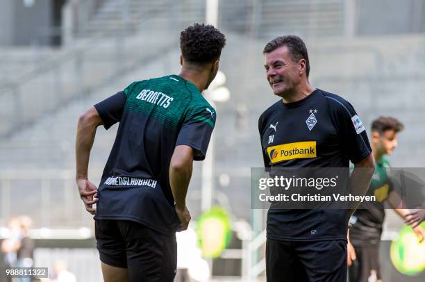 Headcoach Dieter Hecking talks to Keanan Bennetts during a training session of Borussia Moenchengladbach at Borussia-Park on July 01, 2018 in...