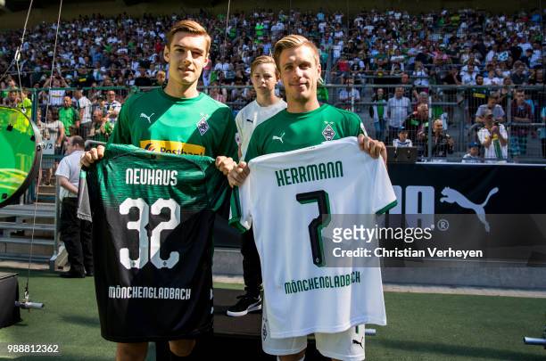 Florian Neuhaus and Patrick Herrmann pose with their new jersey during a training session of Borussia Moenchengladbach at Borussia-Park on July 01,...