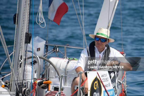 France's skipper Antoine Cousot sails his boat "Metier Interim" from Les Sables d'Olonne Harbour on July 1 at the start of the solo around-the-world...