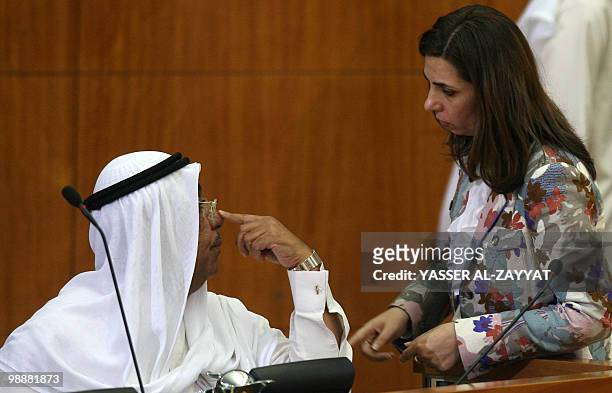 Kuwaiti Rola Dashti talks to Kuwaiti Interior Minister Sheikh Jaber Khaled al-Sabah at the final session of the parliament's current term, in Kuwait...