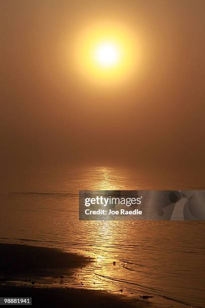 The sun rises over the beach as concern continues that the massive oil spill in the Gulf of Mexico may harm the tourism industry if it comes ashore...