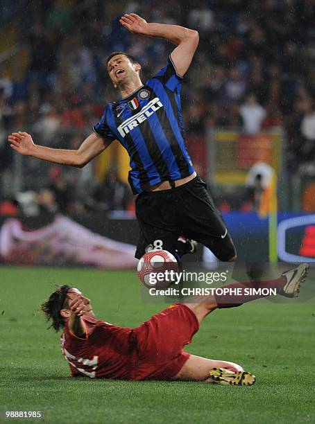 Inter Milan's Brazilian midfielder Thiago Motta is tackled by AS Roma's Brazilian midfielder Rodrigo Ferrante Taddei during their Coppa Italia final...