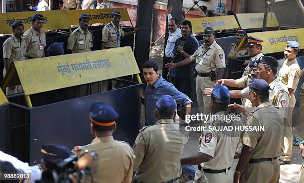 Reporter rushes out from the special bomb proof court at the Arthur Road prison to break the news about Mohammad Ajmal Kasab's death sentence in...