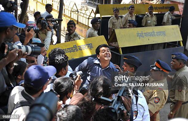 Reporter rushes out from the special bomb proof court at the Arthur Road prison to break the news about Mohammad Ajmal Kasab's death sentence in...