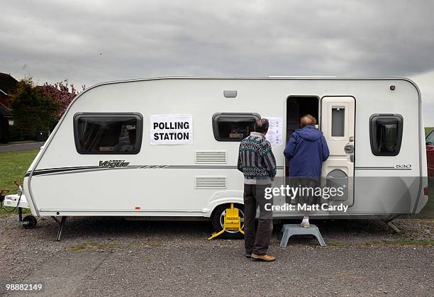 Voters arrive at a caravan being used as a polling station on May 6, 2010 in Ford near Salisbury, England. The UK began voting today in the closest...