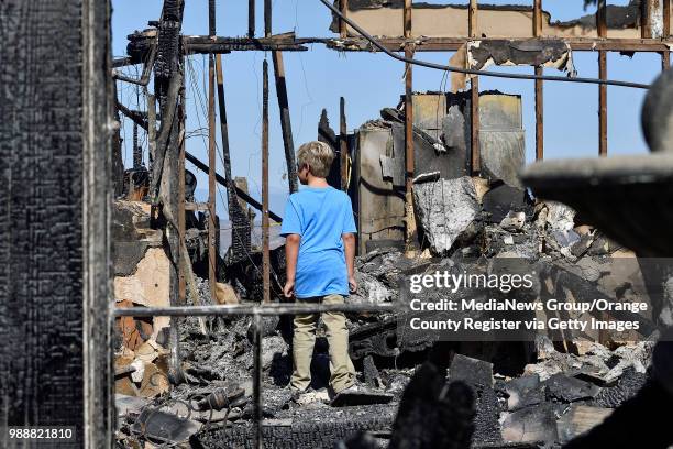 Josh Williamson looks for things to salvage from his home that was destroyed in the Canyon Fire 2 in Anaheim, California, on Tuesday, October 10,...