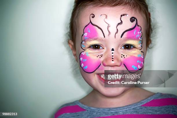 young girl with her face painted as a butterfly - newpremiumuk stock-fotos und bilder