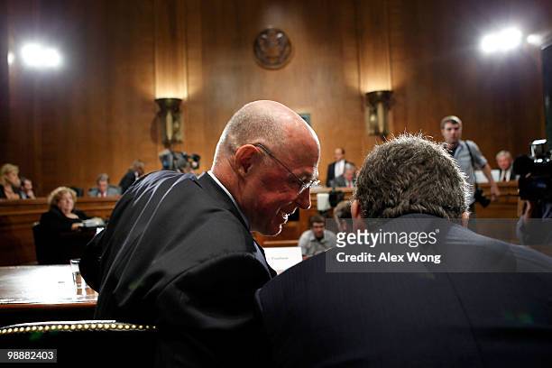 Former U.S. Treasury Secretary Henry Paulson talks to an aide prior to a hearing before the Financial Crisis Inquiry Commission May 6, 2010 on...
