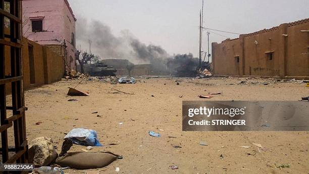 Smoke billows from an army armoured vehicle in Gao after and explosion on July 1, 2018. The French soldiers from the Barkhane mission have been the...