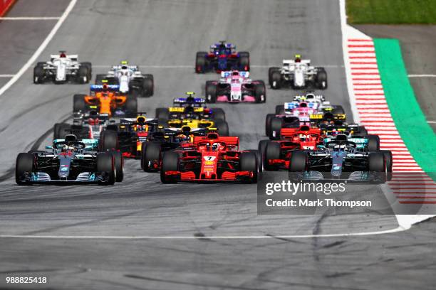 Lewis Hamilton of Great Britain driving the Mercedes AMG Petronas F1 Team Mercedes WO9, Sebastian Vettel of Germany driving the Scuderia Ferrari...