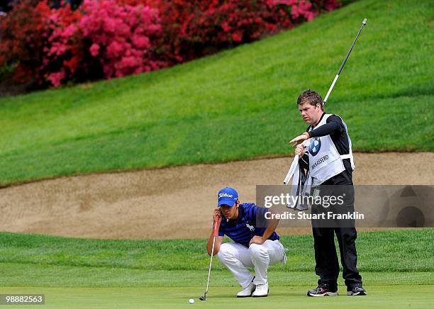 Matteo Manassero of Italy and his caddie line up his putt on the 12th hole during the first round of the BMW Italian Open at Royal Park I Roveri on...