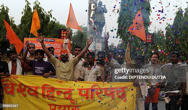 Viswa Hindu Parishad supporters hold flags and throw confetti to celebrate the death sentence of Mohammed Ajmal Amir Kasab in Allahabad on May 6,...