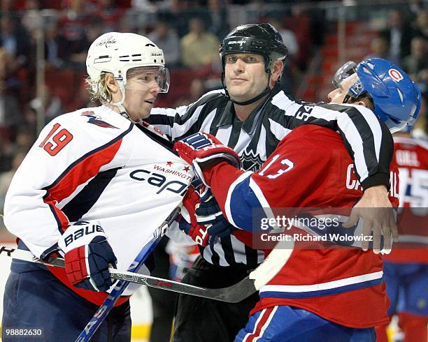 Nicklas Backstrom of the Washington Capitals and Mike Cammalleri of the Montreal Canadiens are seperated by NHL linesman Greg Devorski in Game Three...