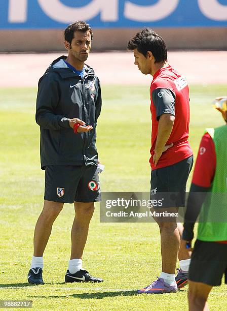 Coach Quique Sanchez Flores of Atletico Madrid chats with Sergio Aguero during a training session held ahead of next week's Europa League Final at...