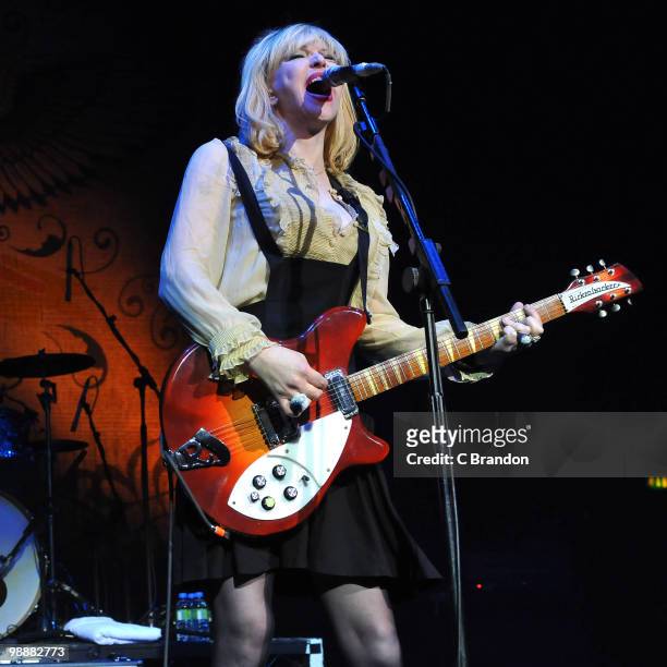 Courtney Love of Hole performs on stage at Brixton Academy on May 5, 2010 in London, England. She plays a Rickenbacker 360 guitar.