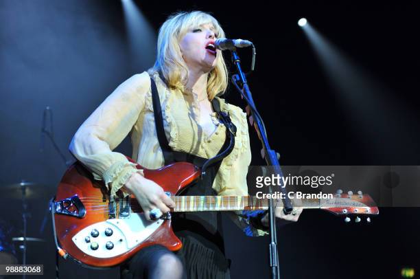 Courtney Love of Hole performs on stage at Brixton Academy on May 5, 2010 in London, England. She plays a Rickenbacker 360 guitar.