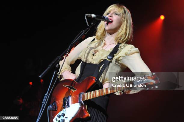 Courtney Love of Hole performs on stage at Brixton Academy on May 5, 2010 in London, England. She plays a Rickenbacker 360 guitar.