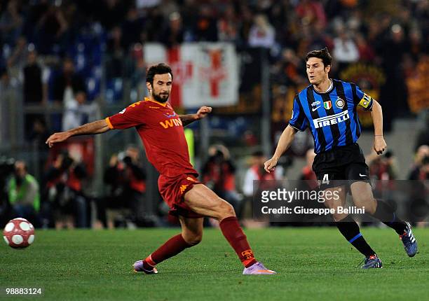 Mirko Vucinic of Roma challenges Javier Zanetti of Inter during the match the Tim Cup between FC Internazionale Milano and AS Roma at Stadio Olimpico...
