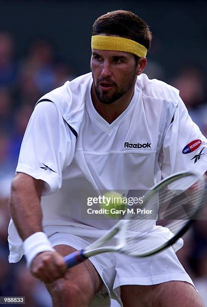 Patrick Rafter of Australia in action against Hicham Arazi of Morroco during the men's third round of The All England Lawn Tennis Championship at...