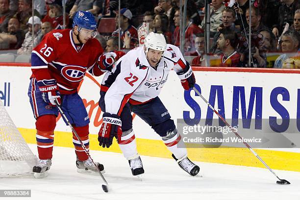 Mike Knuble of the Washington Capitals skates with the puck while being defended by Josh Gorges of the Montreal Canadiens in Game Four of the Eastern...