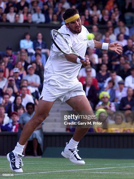 Patrick Rafter of Australia in action against Hicham Arazi of Morroco during the men's third round of The All England Lawn Tennis Championship at...