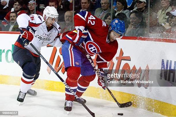 Dominic Moore of the Montreal Canadiens and Shaone Morrisonn of the Washington Capitals battle for the puck in Game Six of the Eastern Conference...