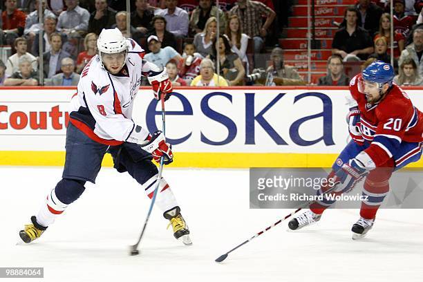 Alex Ovechkin of the Washington Capitals shoots the puck in front of Ryan O'Byrne of the Montreal Canadiens in Game Six of the Eastern Conference...