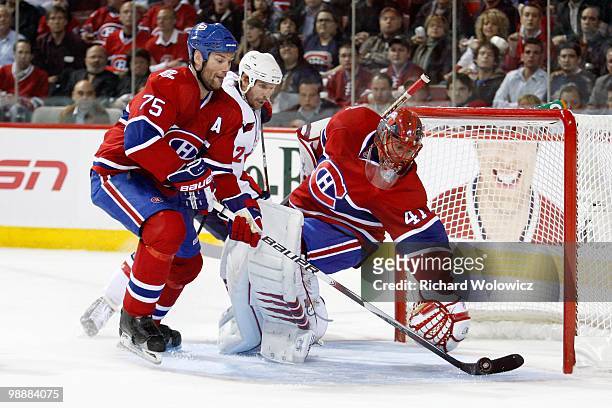 Hal Gill picks up the loose puck in front of Jaroslav Halak of the Montreal Canadiens and Mike Knuble of the Washington Capitals in Game Six of the...