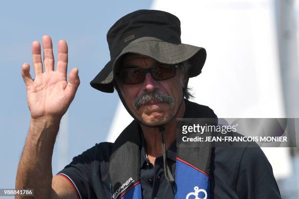 France skipper Loic Lepage gestures on his boat "Laaland" waves as he sets sail from Les Sables d'Olonne Harbour on July 1 at the start of the solo...