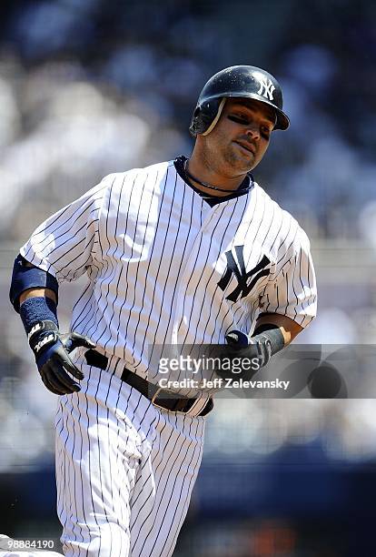 Nick Swisher of the New York Yankees hits a home run against the Baltimore Orioles at Yankee Stadium on May 5, 2010 in the Bronx borough of New York...