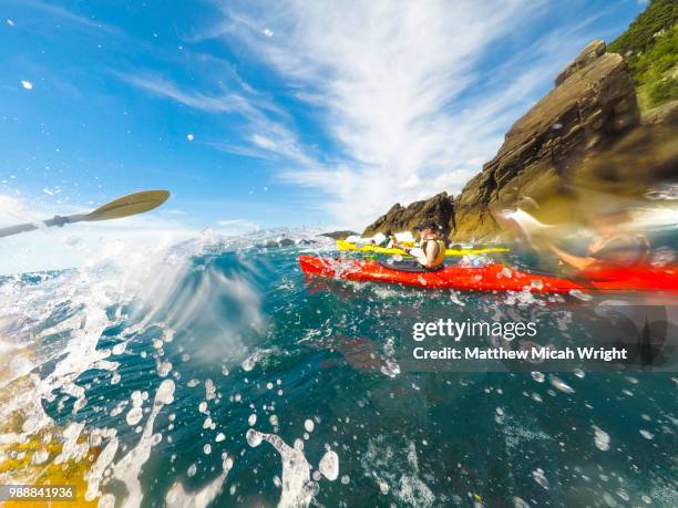 kayakers paddle around exploring cathedral cove on new zealand's coromandel peninsula. - cathedral cove stock pictures, royalty-free photos & images