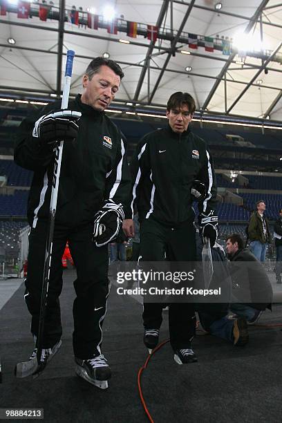 Assistant coach Harold Kreis and national coach Uwe Krupp of Germany walk to a training session at the Veltins Arena ahead of the IIHF World...