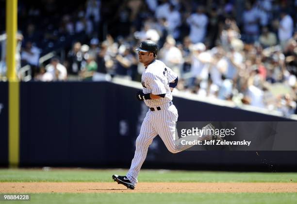 Nick Swisher of the New York Yankees hits a home run against the Baltimore Orioles at Yankee Stadium on May 5, 2010 in the Bronx borough of New York...
