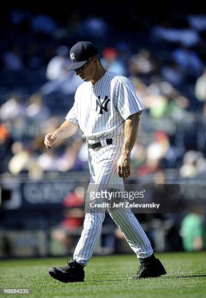 Joe Girardi of the New York Yankees walks to the dugout against the Baltimore Orioles at Yankee Stadium on May 5, 2010 in the Bronx borough of New...