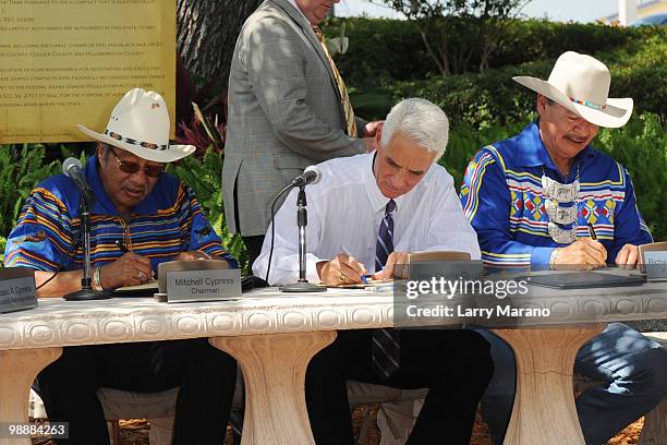 Mitchell Cypress, Governor Charlie Crist and Richard Bowers attend the signing of the Seminole Compact at Seminole Hard Rock Hotel on May 5, 2010 in...