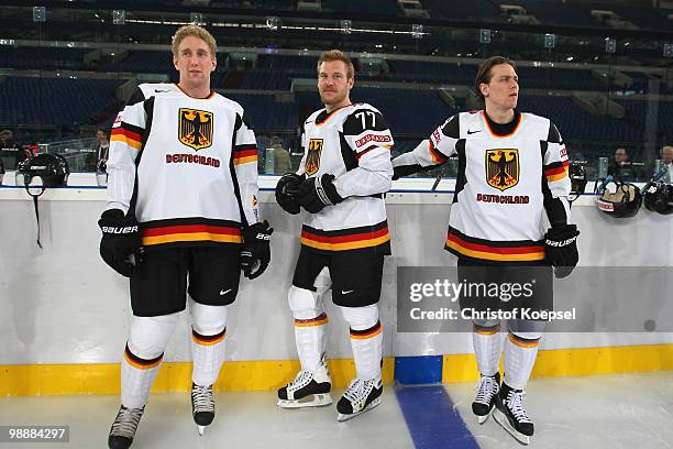 Jason Holland, Nikolai Goc and Alexander Barta of Germany look on during a training session at the Veltins Arena ahead of the IIHF World Championship...