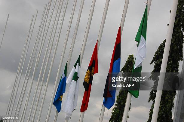 Flags are pictured at half mast in tribute to late Nigerian President Umaru Yar'Adua at Abuja airport on May 6, 2010. Dozens of armed soldiers and...