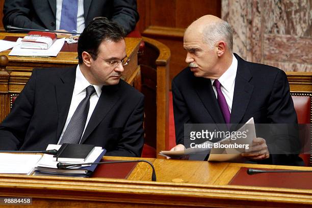 George Papandreou, Greece's prime minister, right, speaks with George Papaconstantinou, Greece's finance minister, in the Greek parliament in Athens,...