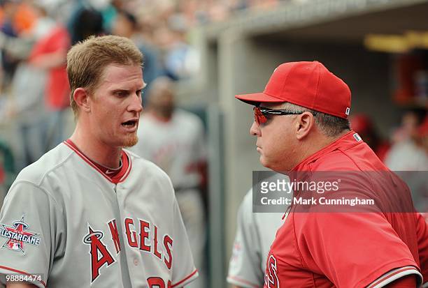 Jered Weaver of the Los Angeles Angels of Anaheim talks with manager Mike Scioscia in the dugout against the Detroit Tigers during the game at...