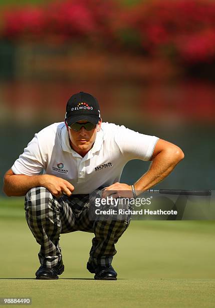 Henrik Stenson of Sweden lines up a putt on the 16th green during the first round of THE PLAYERS Championship held at THE PLAYERS Stadium course at...