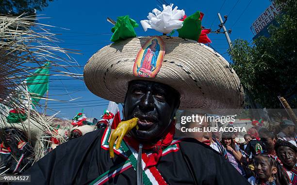 People rally along the streets of the Penon de los Banos neighbourhood in Mexico City, May 5 2010, commemorating Mexico's victory over France in the...