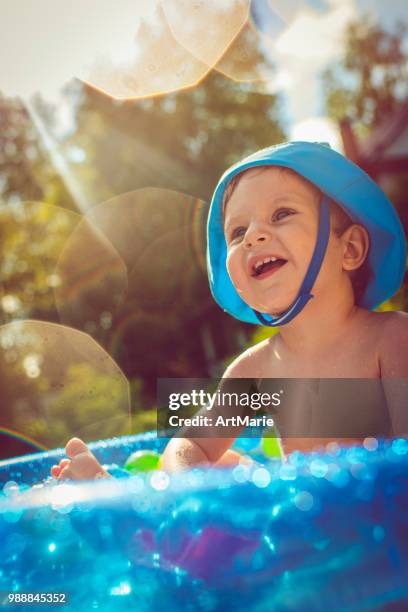 little boy in swimming pool - artmarie stock pictures, royalty-free photos & images