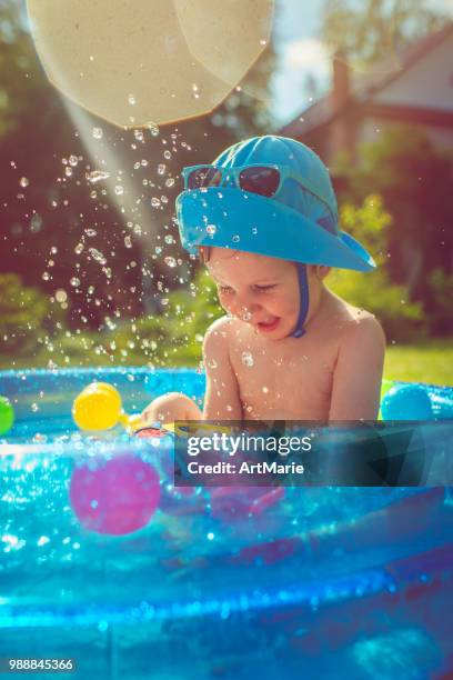 little boy in swimming pool - artmarie stock pictures, royalty-free photos & images