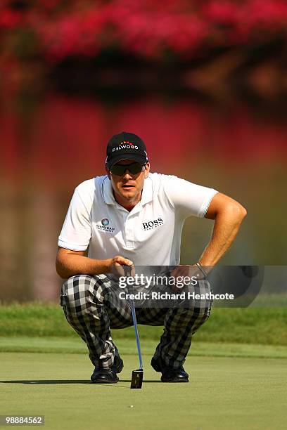 Henrik Stenson of Sweden lines up a putt on the 16th green during the first round of THE PLAYERS Championship held at THE PLAYERS Stadium course at...