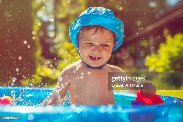 little boy in swimming pool - artmarie stock pictures, royalty-free photos & images