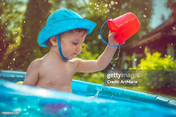 little boy in swimming pool - artmarie stock pictures, royalty-free photos & images