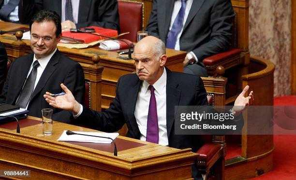 George Papandreou, Greece's prime minister, right, gestures as George Papaconstantinou, Greece's finance minister, listens in the Greek parliament in...