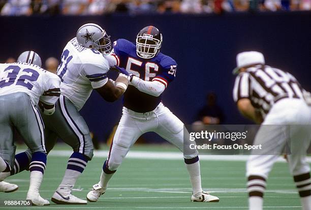 S: Linebacker Lawrence Taylor of the New York Giants is blocked by offensive tackle Nate Newton of the Dallas Cowboys circa early 1990's during an...